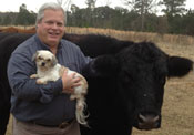 Dr. William Mangham with dog, Emma, and steer, Jack