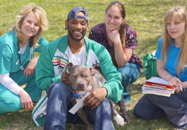 Dr. Susan Krebsbach and other PFL volunteers pose with a client and his dog at a Milwaukee Pets for Life event